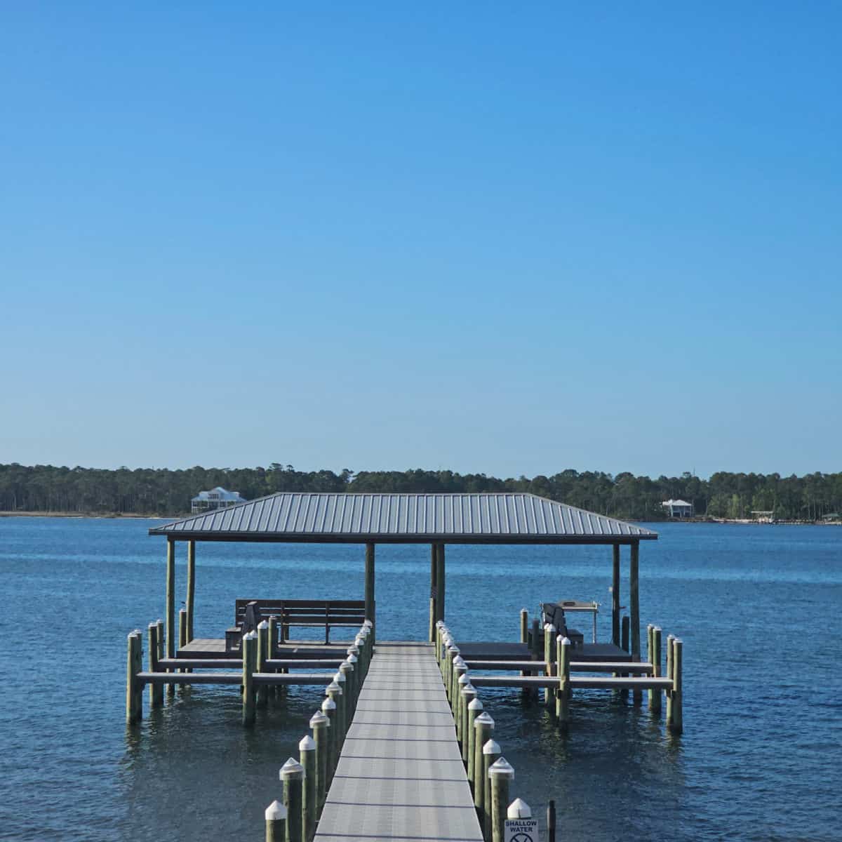 Covered fishing pier with benches over the water