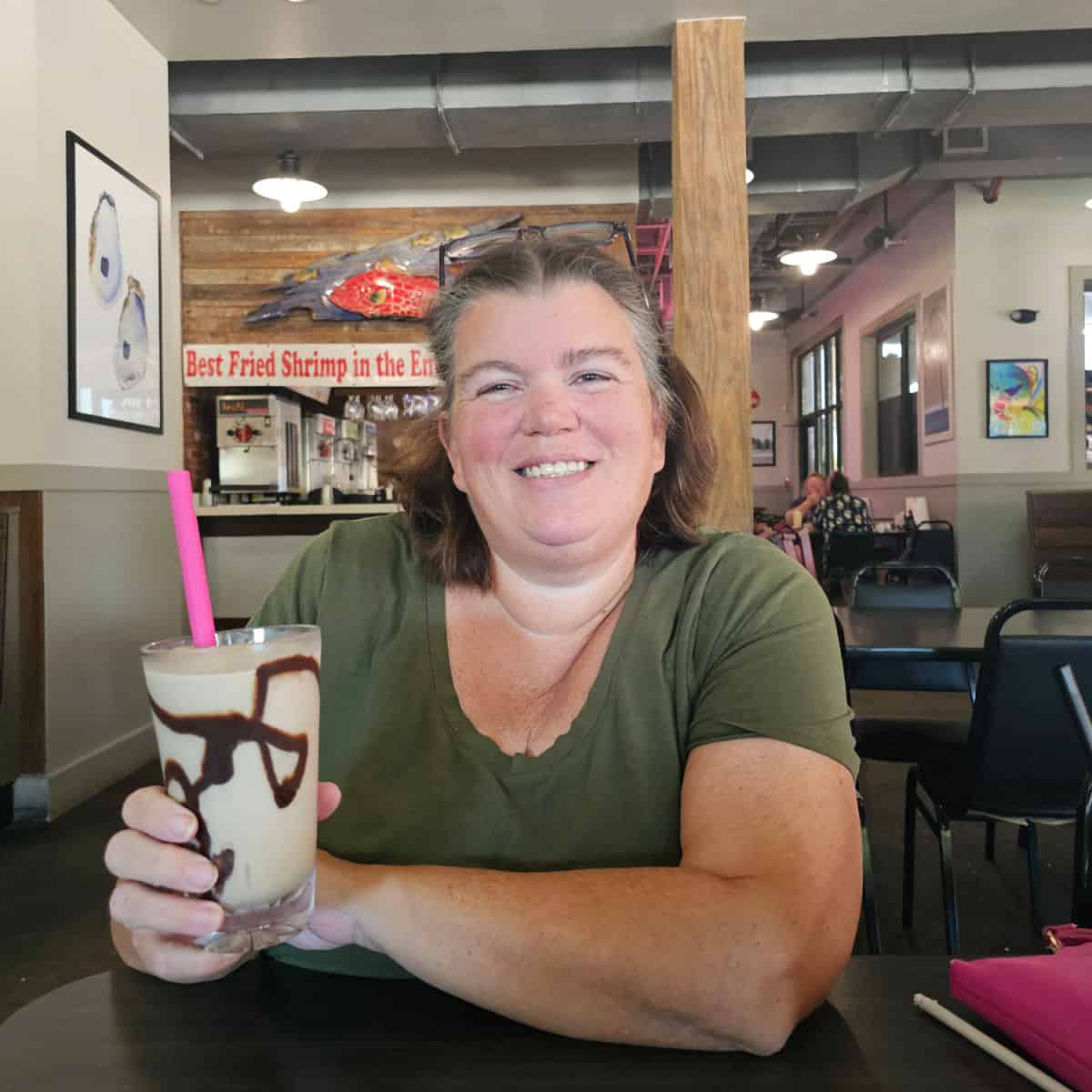 Tammilee holding a bushwacker with chocolate swirl in Doc's Seafood and Steak