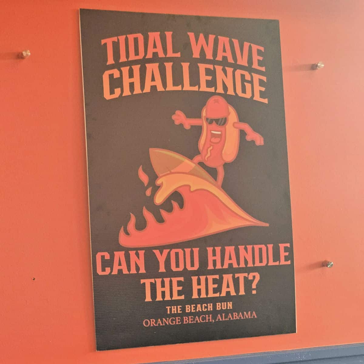 The tidal wave challenge sign with a hot dog surfing a red fire wave