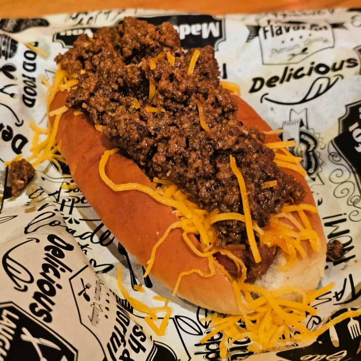 chili dog on a black and white paper
