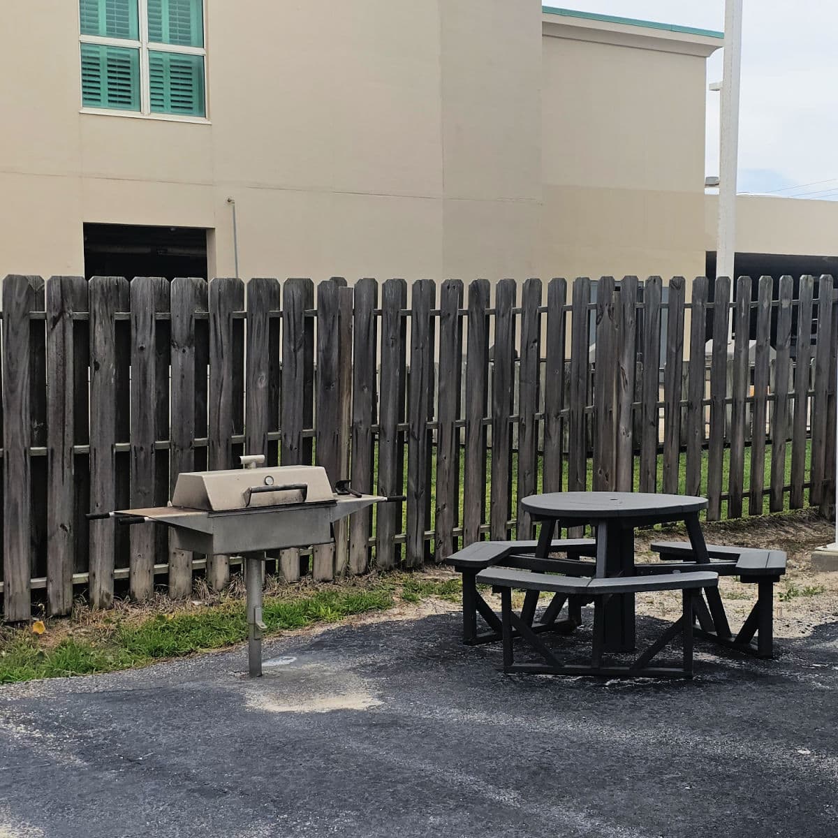 barbecue and picnic table near a brown fence at Harbor House