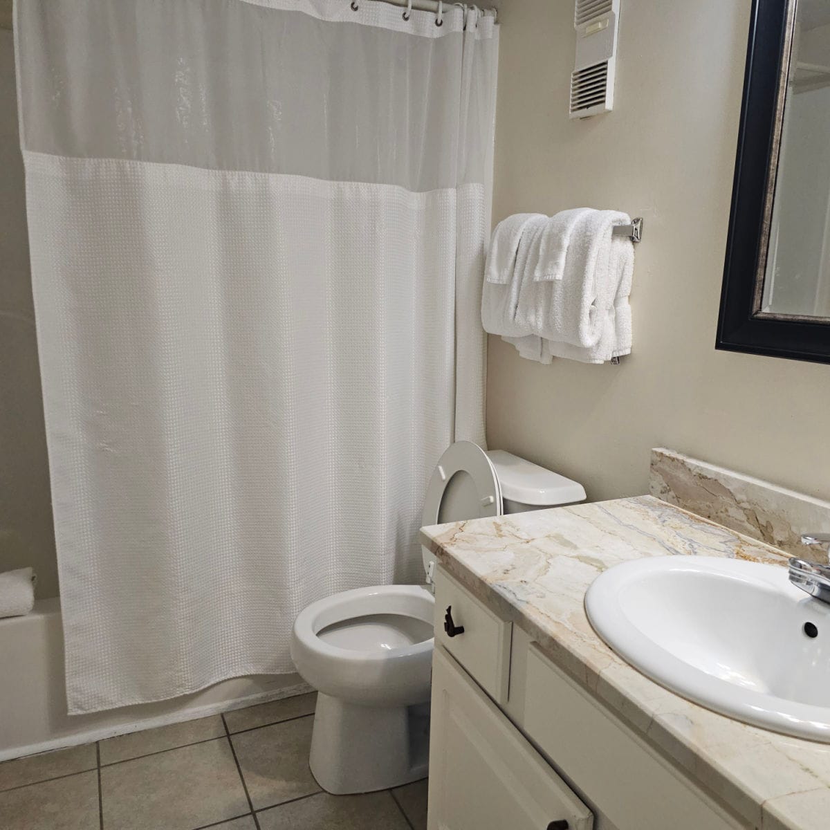 bathroom with white shower curtain