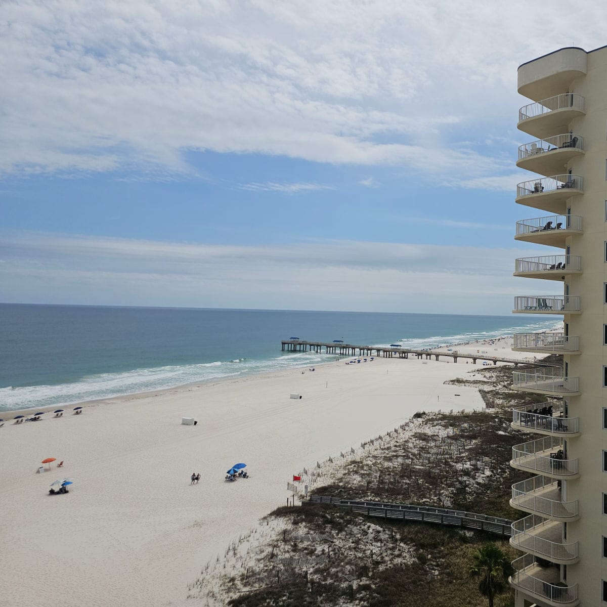 looking out over the beach with a pier in the background, Gulf of Mexico