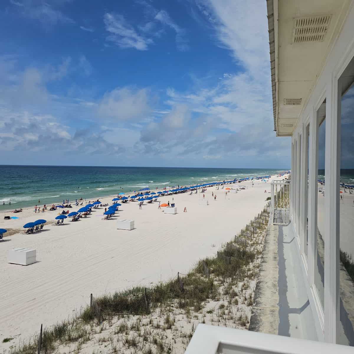 Looking down the side of the building to the white sand and Gulf