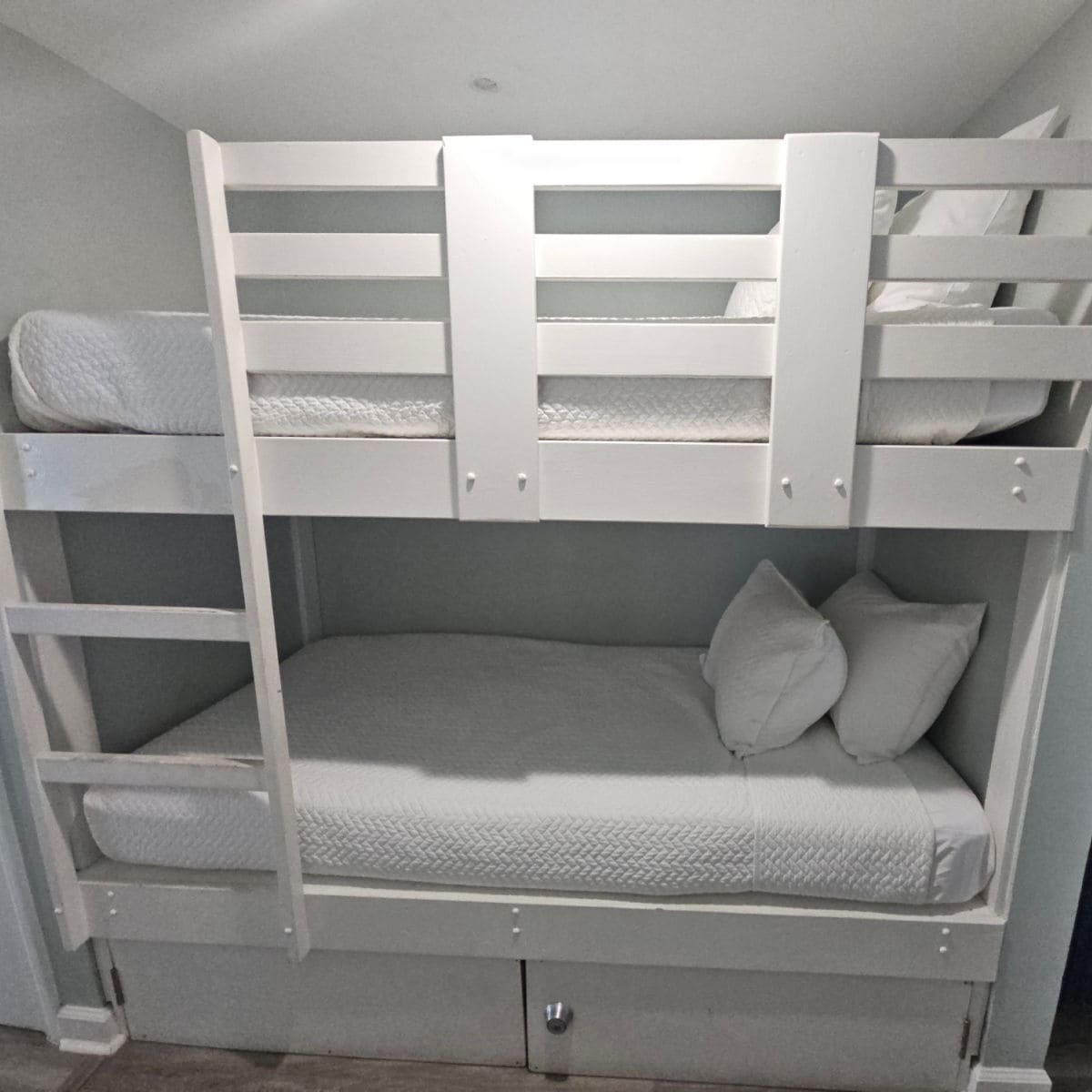 white bunkbed with white linens