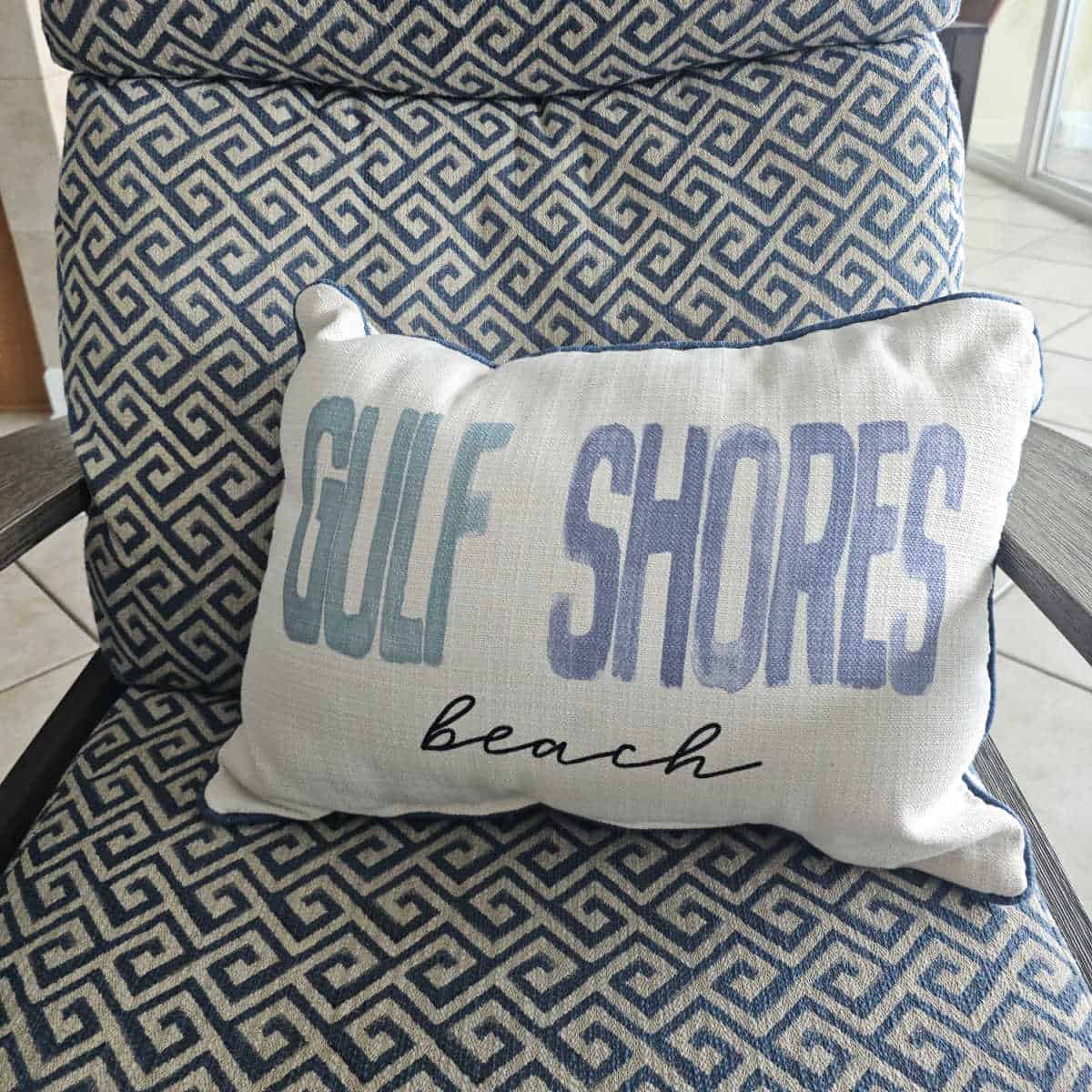 Gulf Shores Beach pillow on a blue and white chair