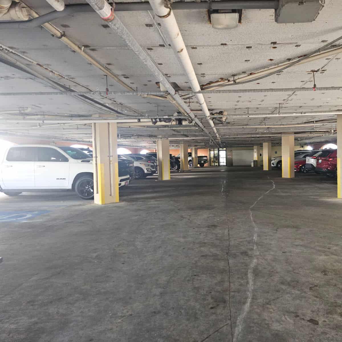 parkign under the building with cars in parking spots Harbour Place
