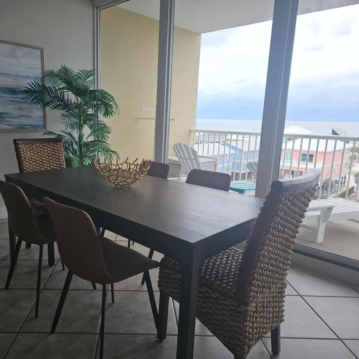 dining area with a balcony overlooking the Gulf and beach houses