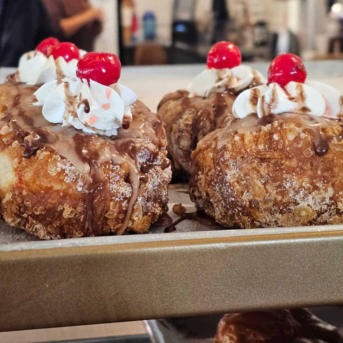 parlor doughnuts on a trail covered with whipped cream and a cherry