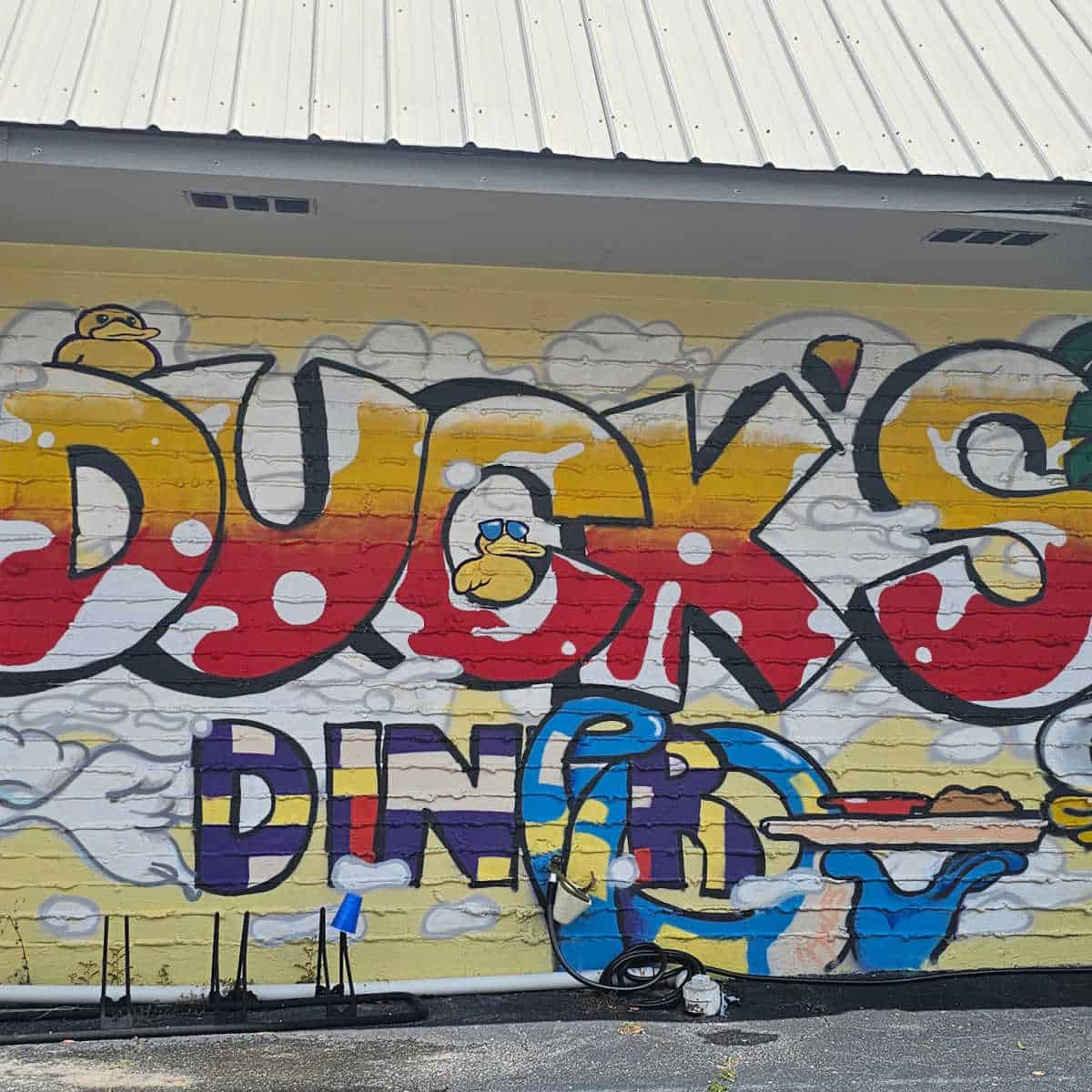 Ducks Diner mural on the side of the building