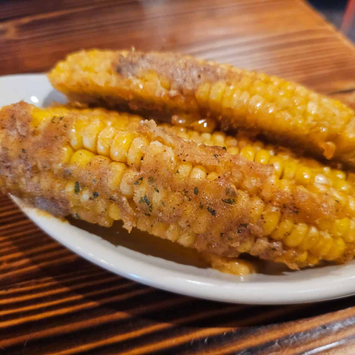 Elote corn on a white plate