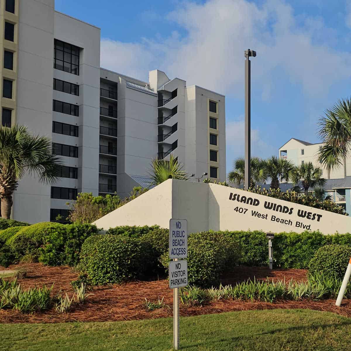 Island Winds West sign with building in the background