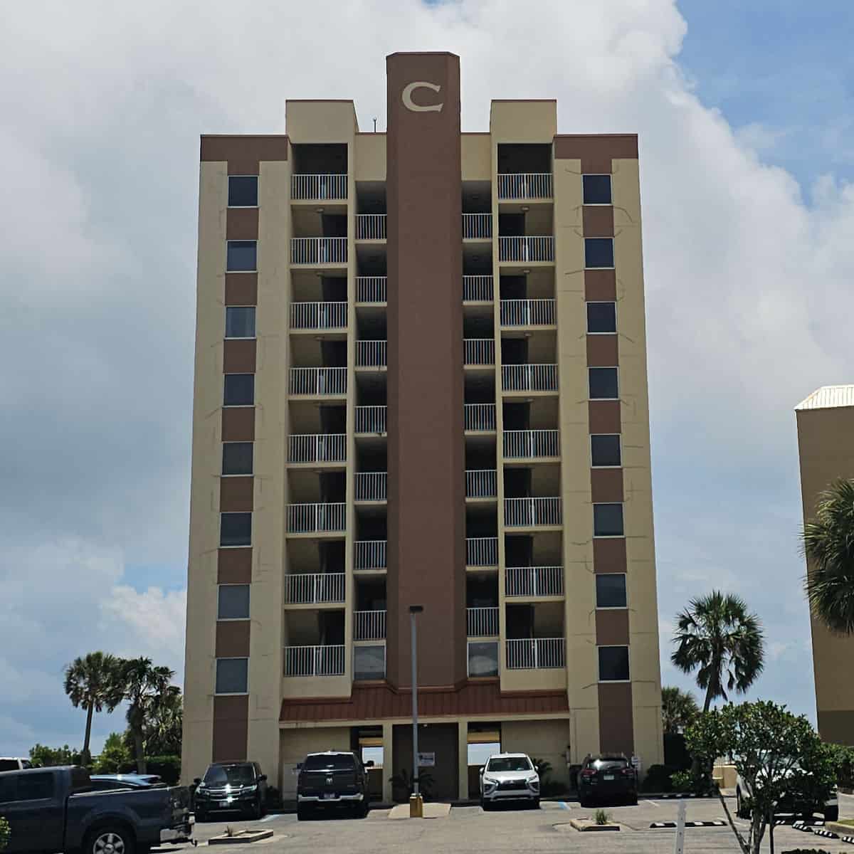 Tall condo building with a large C at the top