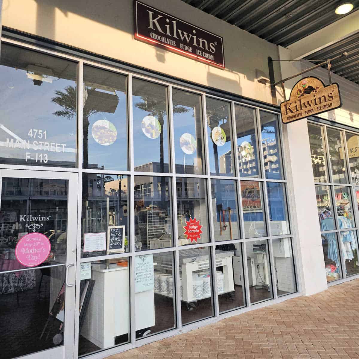 Kilwins exterior with sign over the glass windows and doors