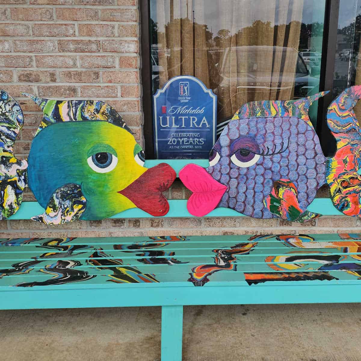 colorful fish on a bench next to a building