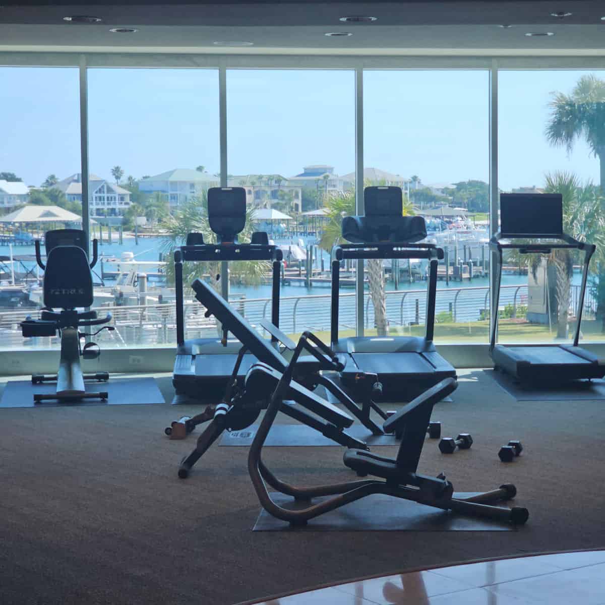 fitness center with treadmill and bike looking out over the marina
