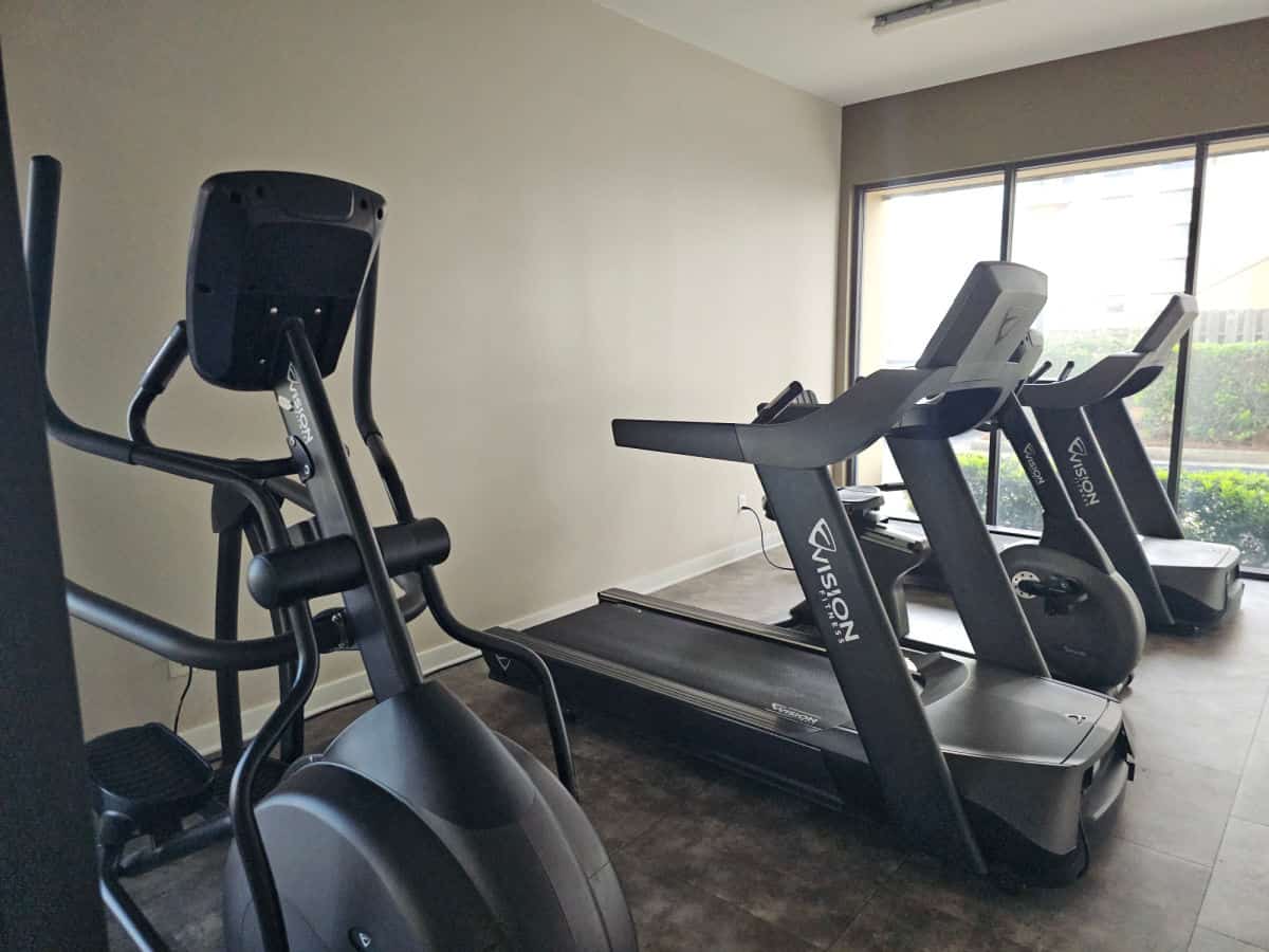 fitness center with treadmills and a eliptical in a small room
