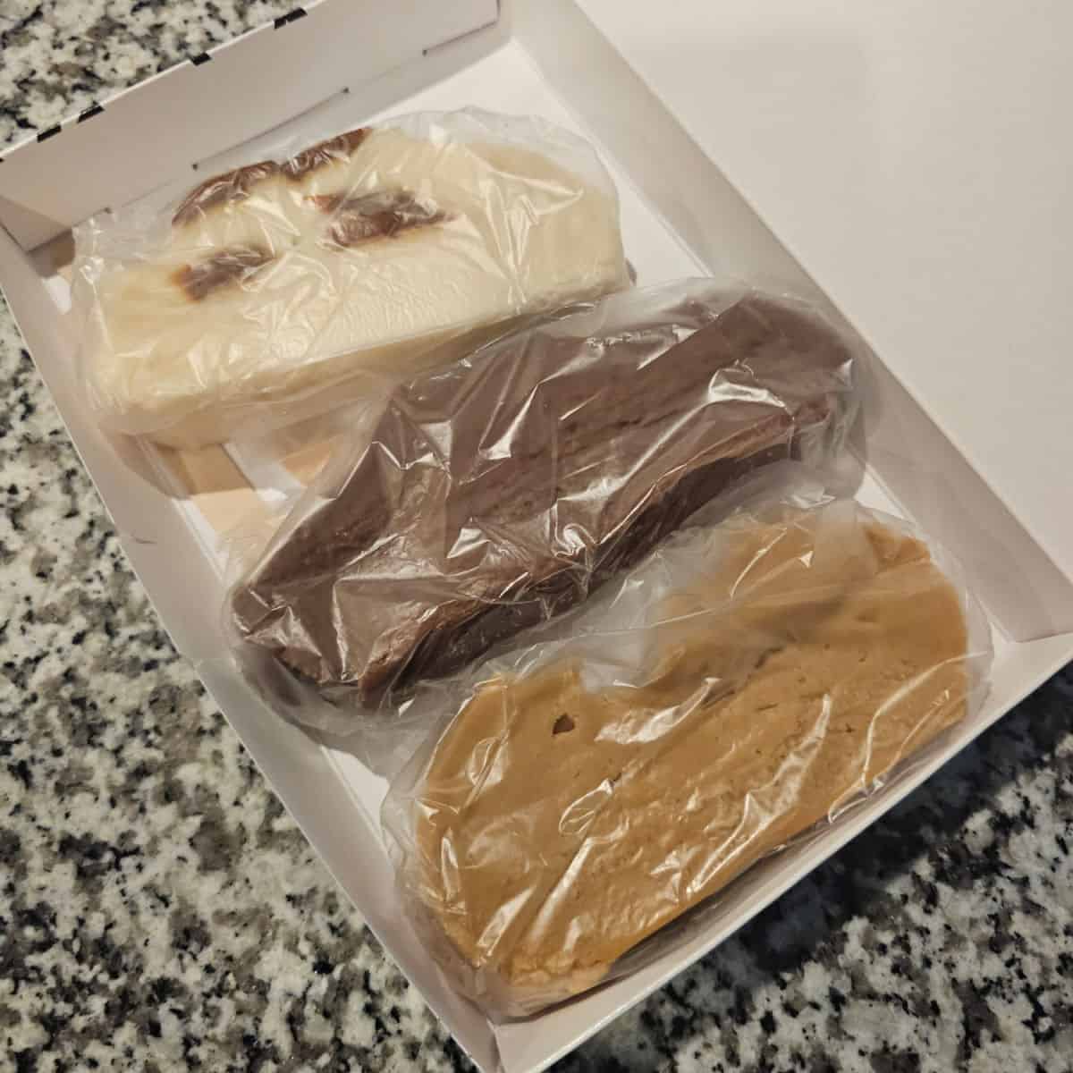 three different fudge slices in a white box