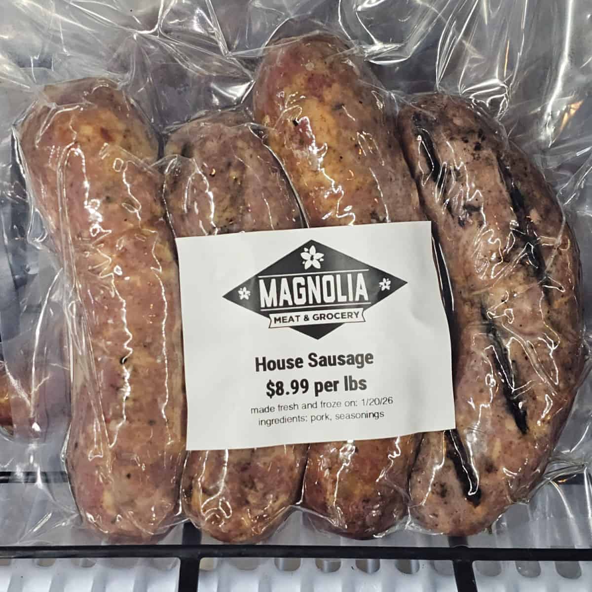 Magnolia Meat & Grocery label on a shrink wrapped package of sausage