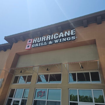 Hurricane Grill & Wings sign over the glass entrance to the restaurant