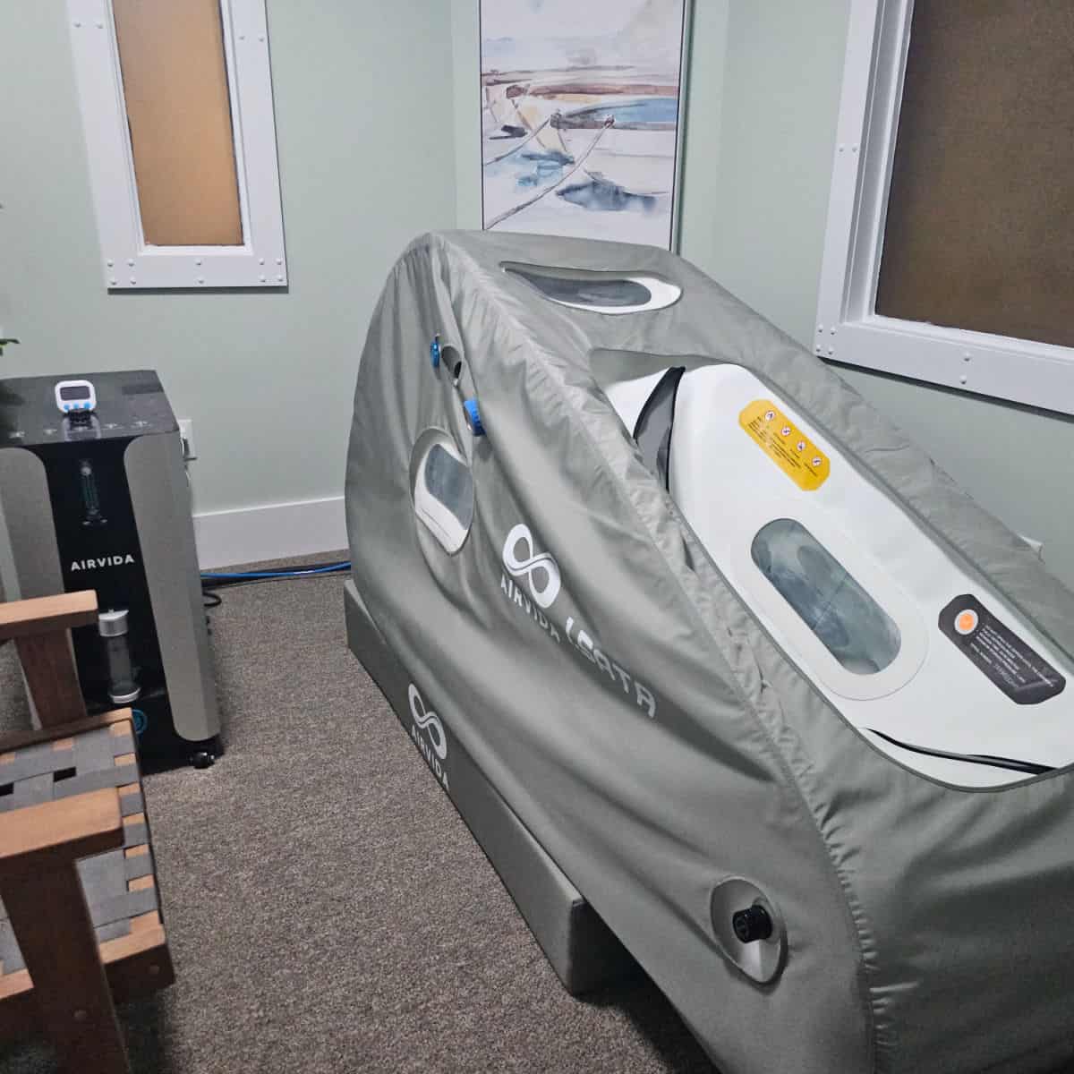 hyperbaric chamber machine next to an airvida oxygen tank