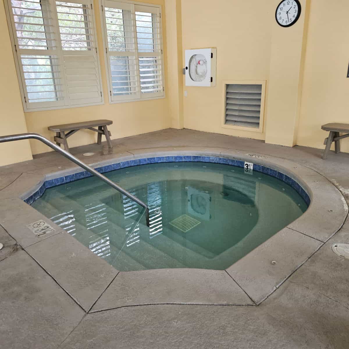 hot tub with a bench near it