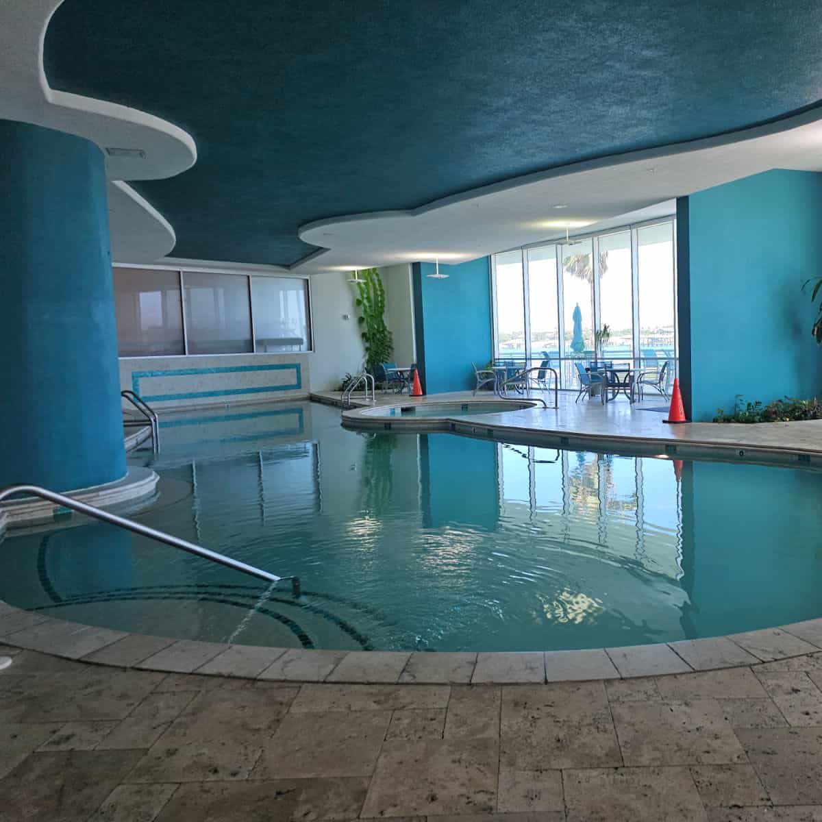 Indoor pool with windows out to the pool deck
