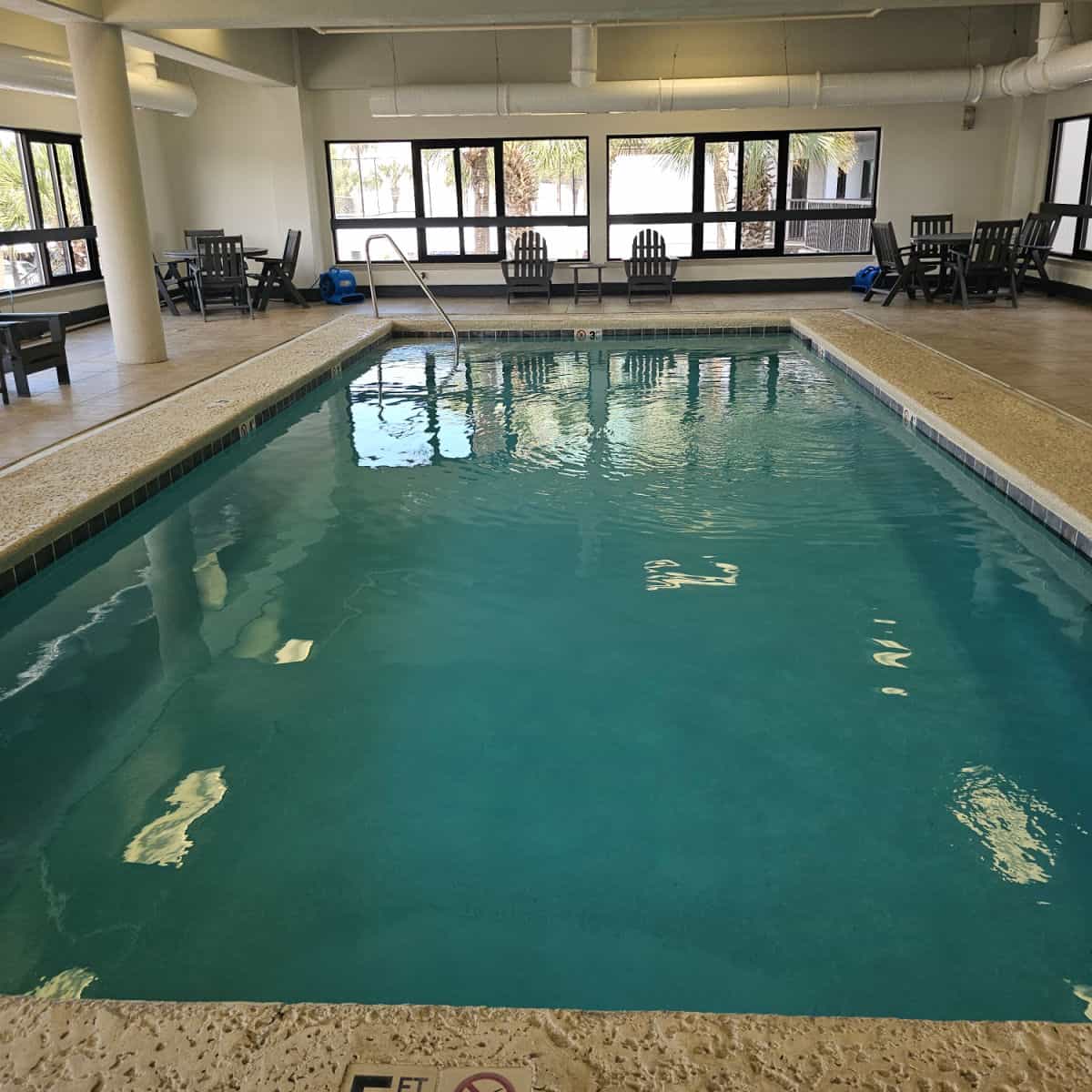 Indoor pool with deck chairs inside a building