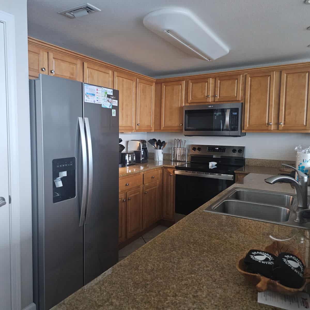 kitchen with stainless steel appliances, brown wood cabinets