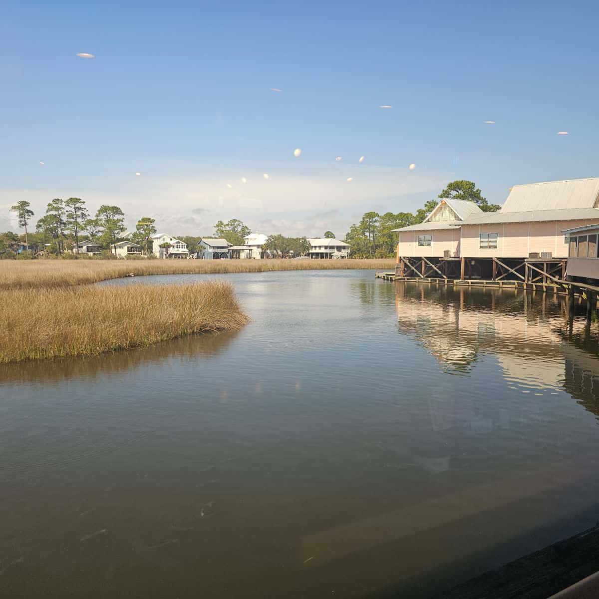 looking out the window to houses on stilts and little lagoon