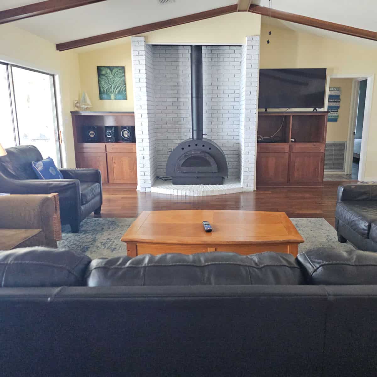 living room with fireplace in a white brick area