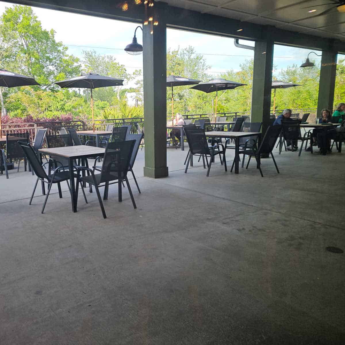 outdoor seating area with umbrellas in the far area