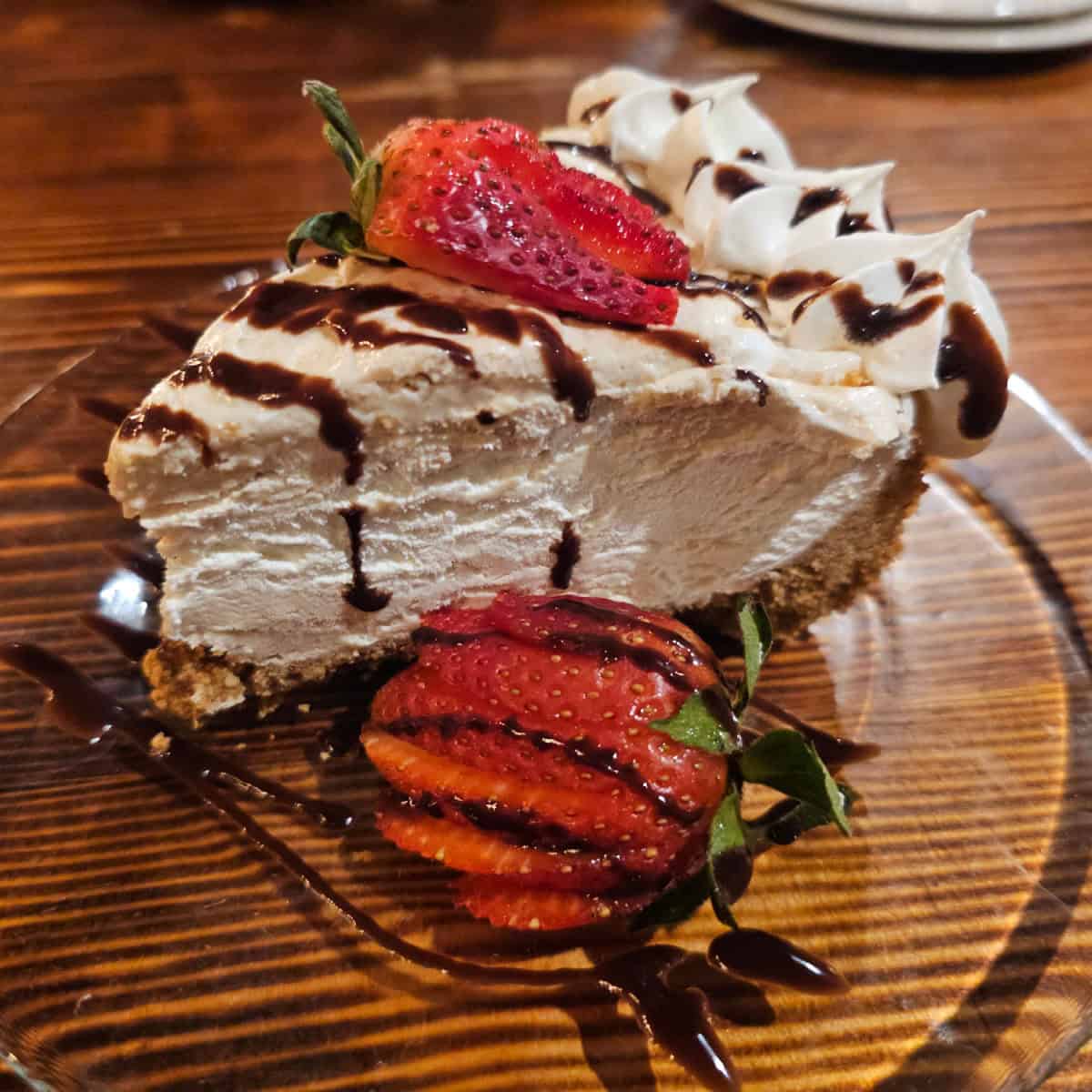 Peanut Butter Pie with strawberries on a glass plate