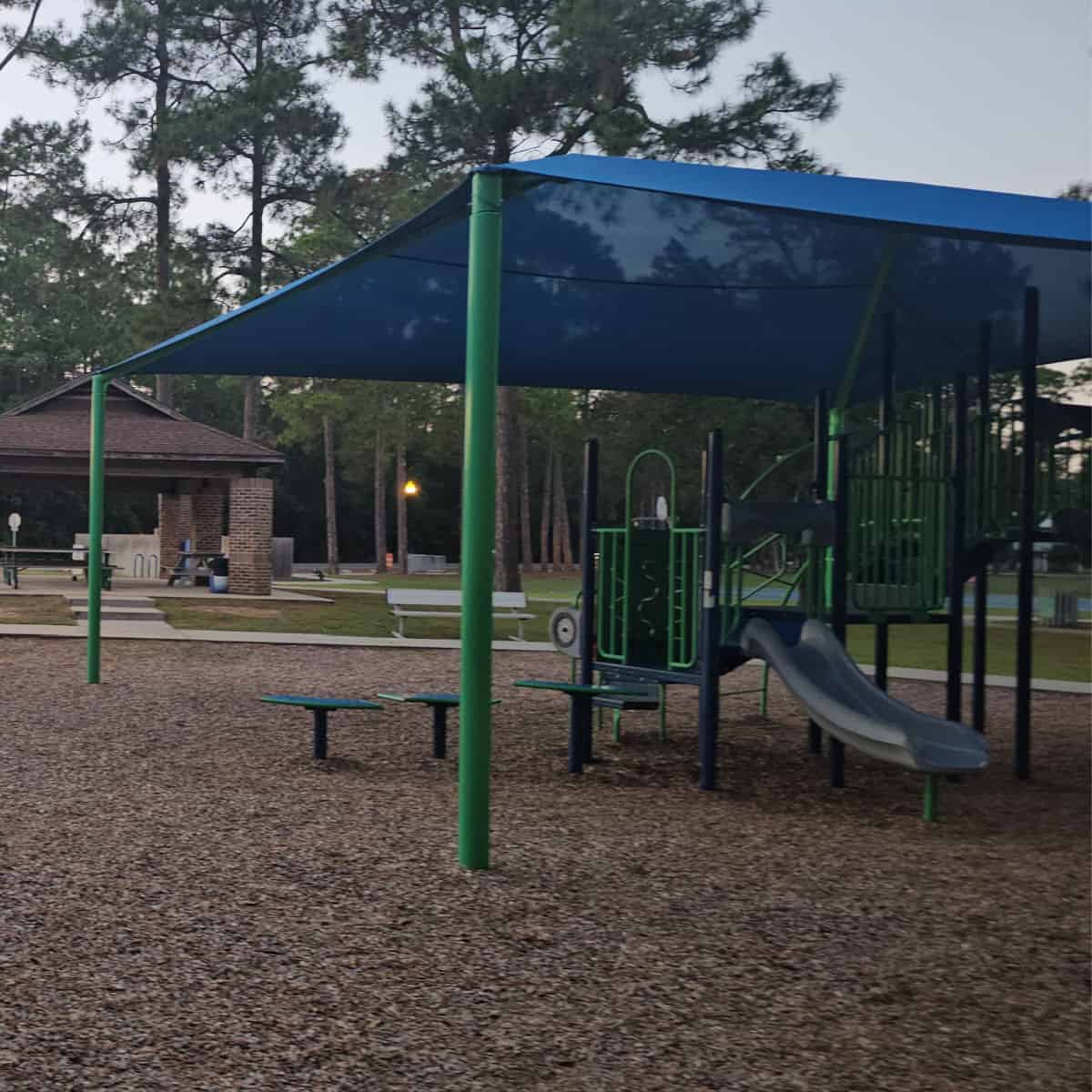 kids play area with slide under a blue cover