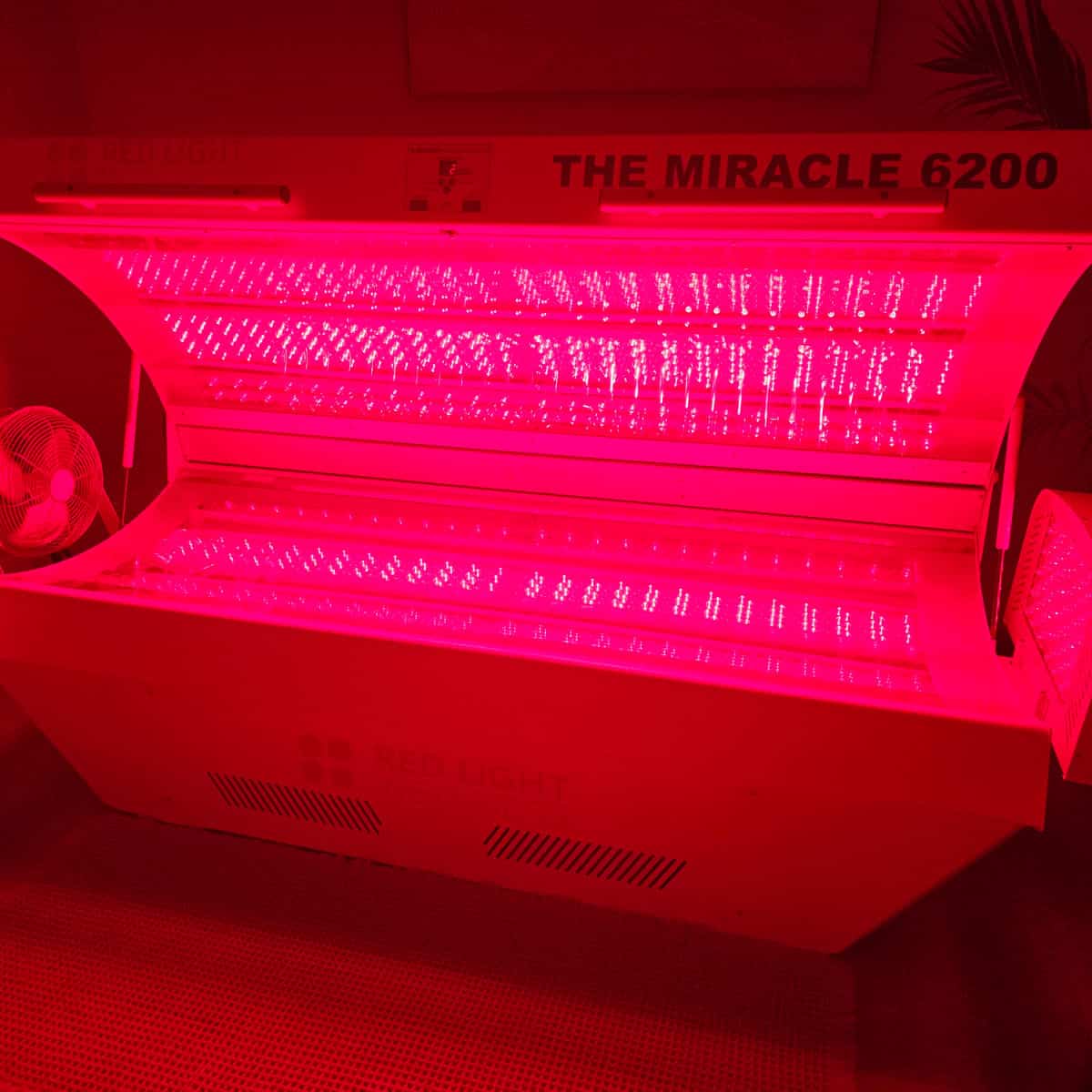 Red light therapy bed with the lights on