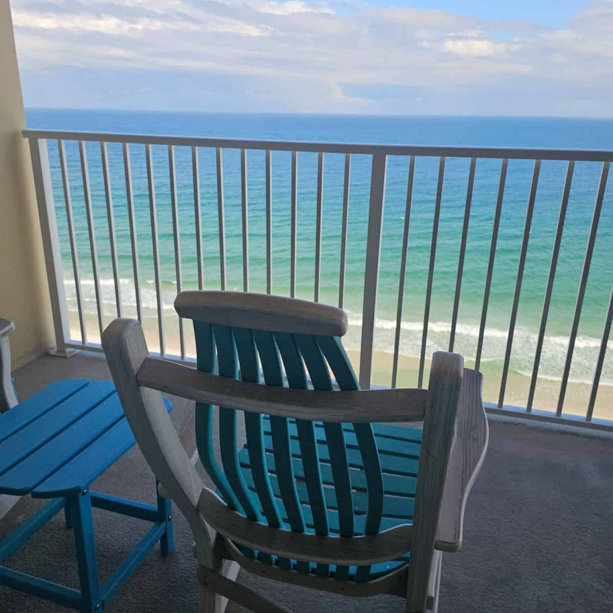 Rocking chair and table on the balcony with the Gulf in the background