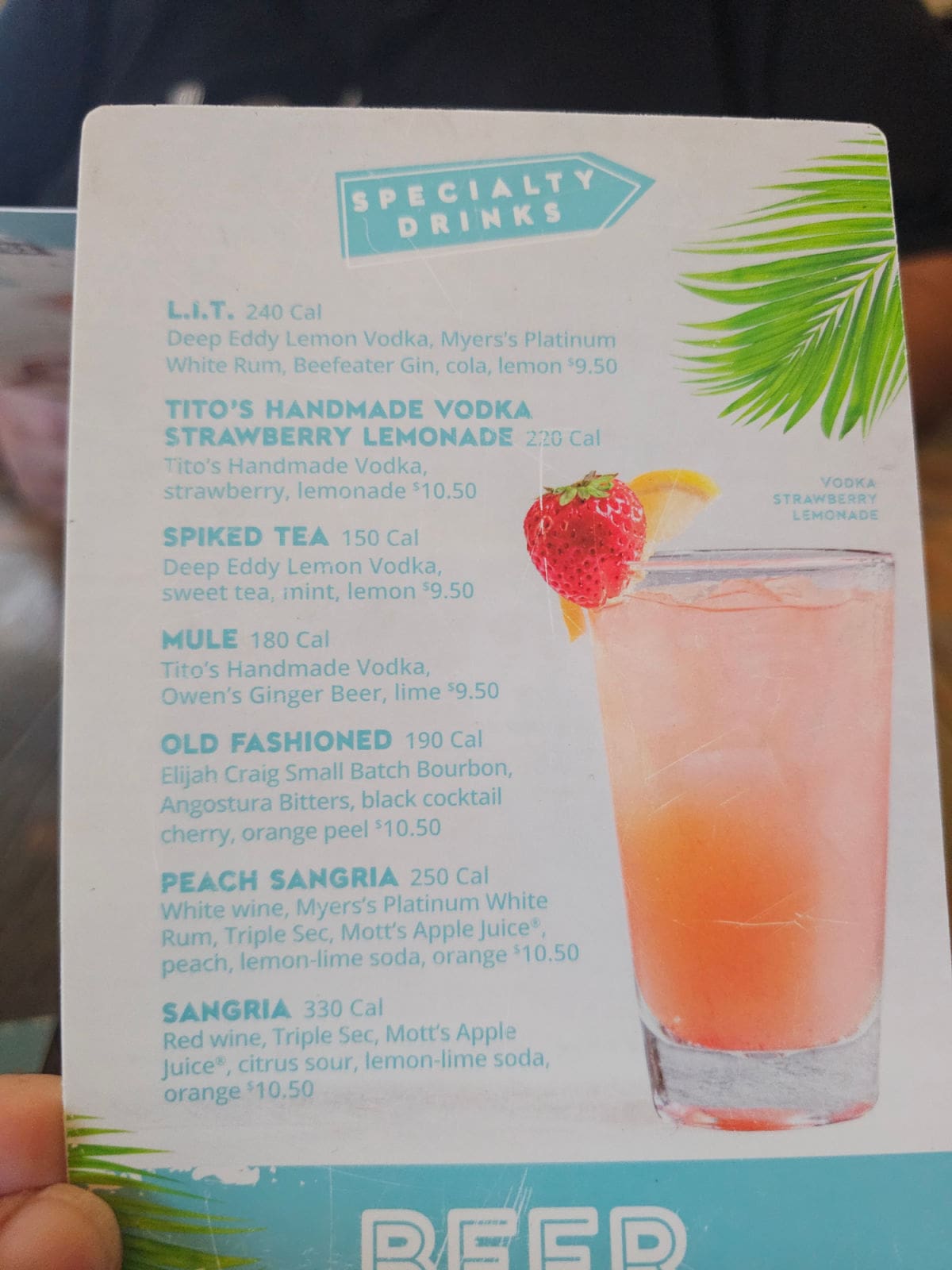 Specialty Drinks menu with a glass on it