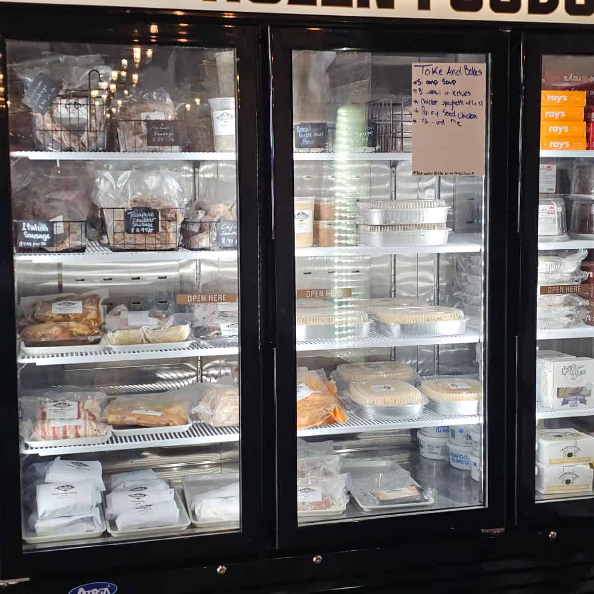 refrigerator case with premade take and bake food on shelves