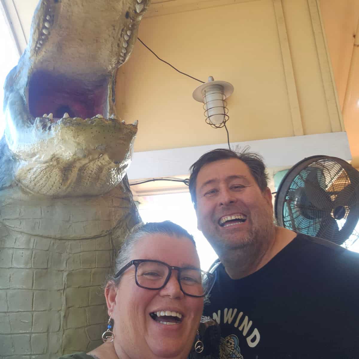 Tammilee and John by a giant alligator at Oyster House