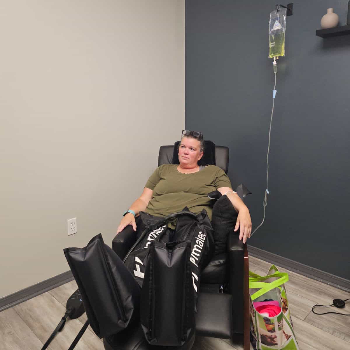 tammilee in a chair with an IV hanging next to her, pneumatic leg compresses on