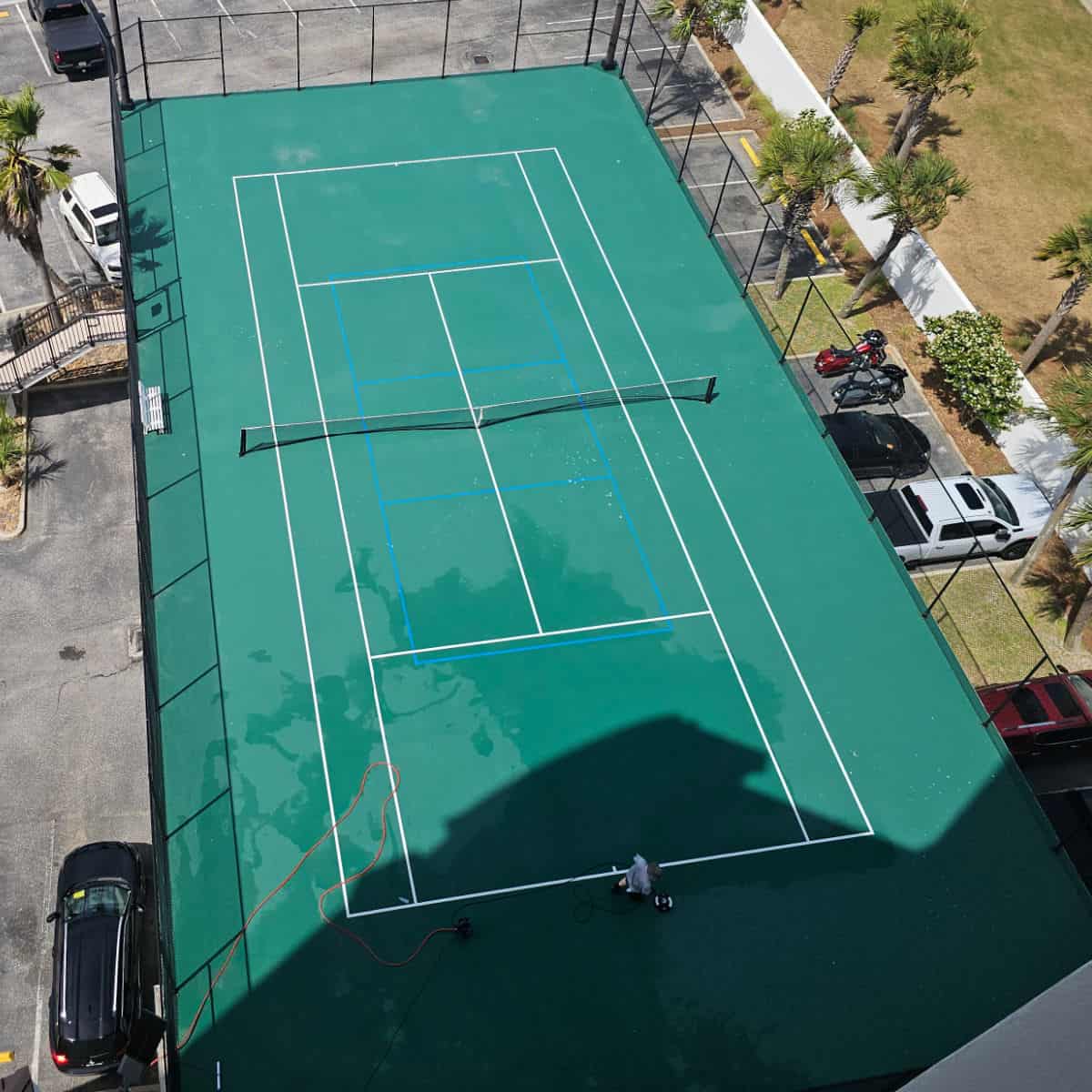 Looking down over the tennis court parking lot below