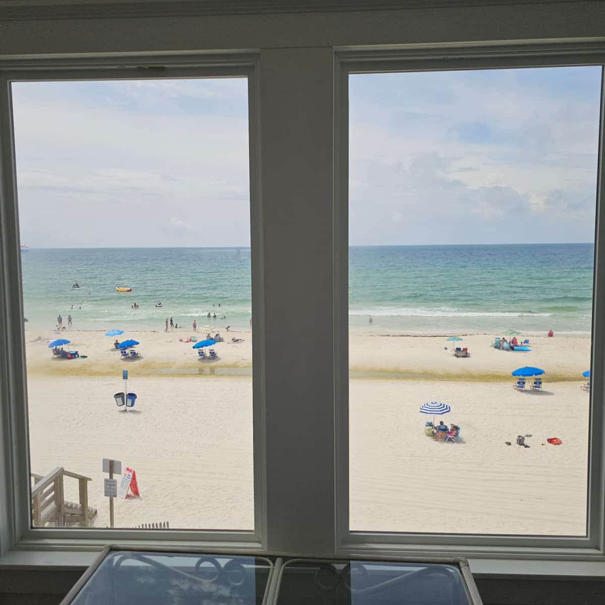 looking out the window to people on the beach and the Gulf