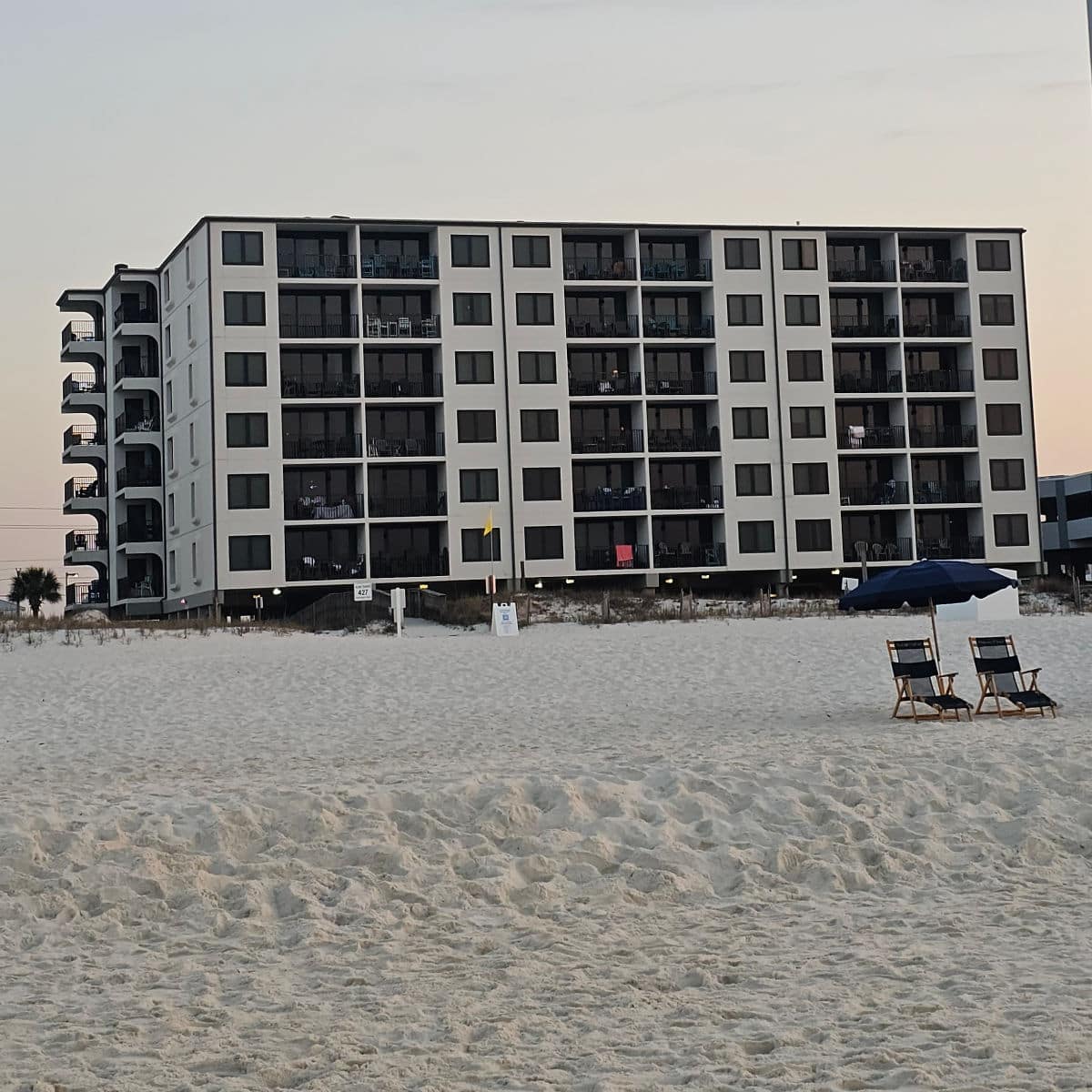 looking up the sand to the outside of Island Sunrise building