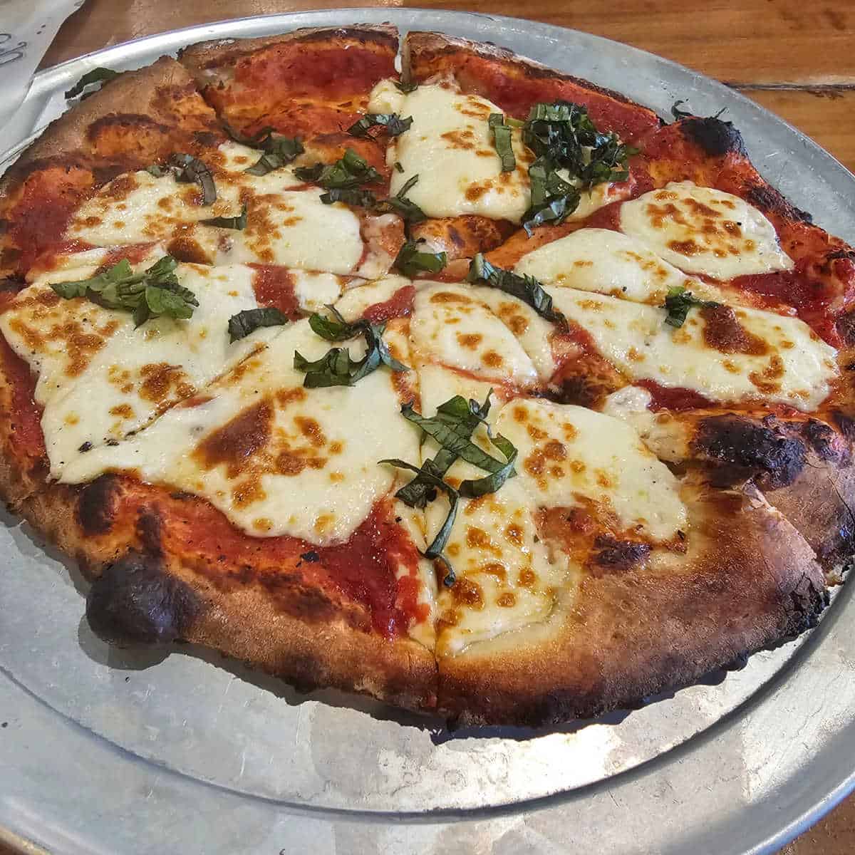 cheese pizza on a metal tray