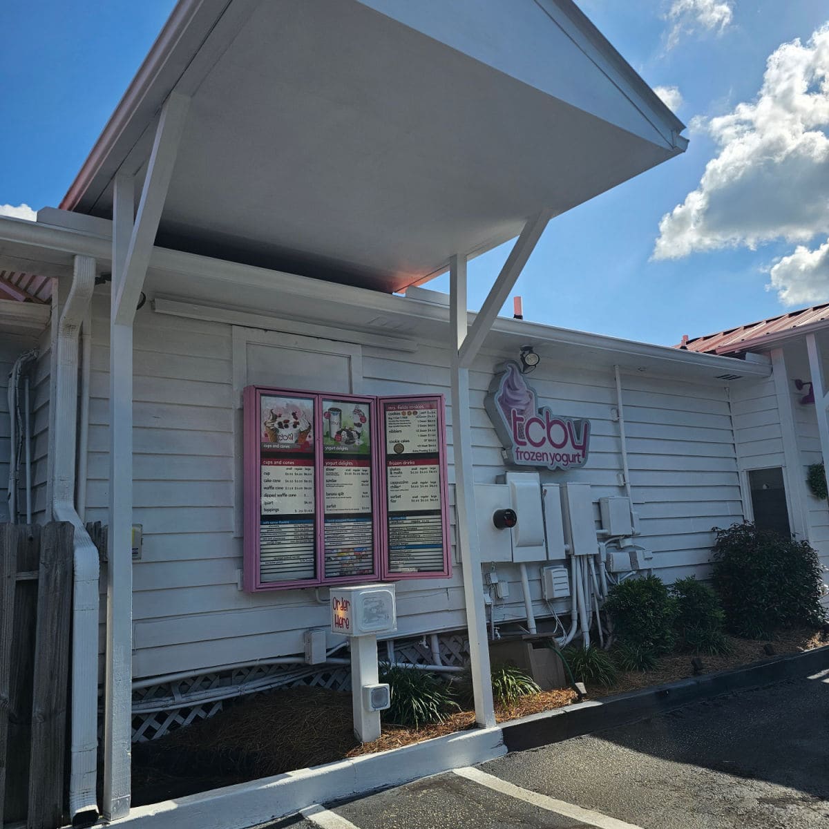 White building with TCBY and menu board