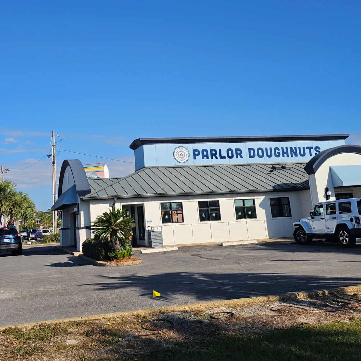 parlor doughnuts exterior with a jeep parked in the parking lot