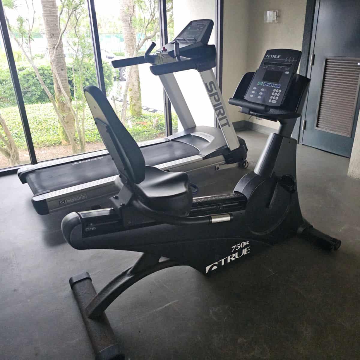 fitness center with a treadmill and bike