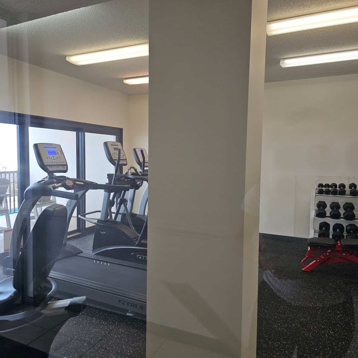 fitness center with treadmill and elipticals and free weights