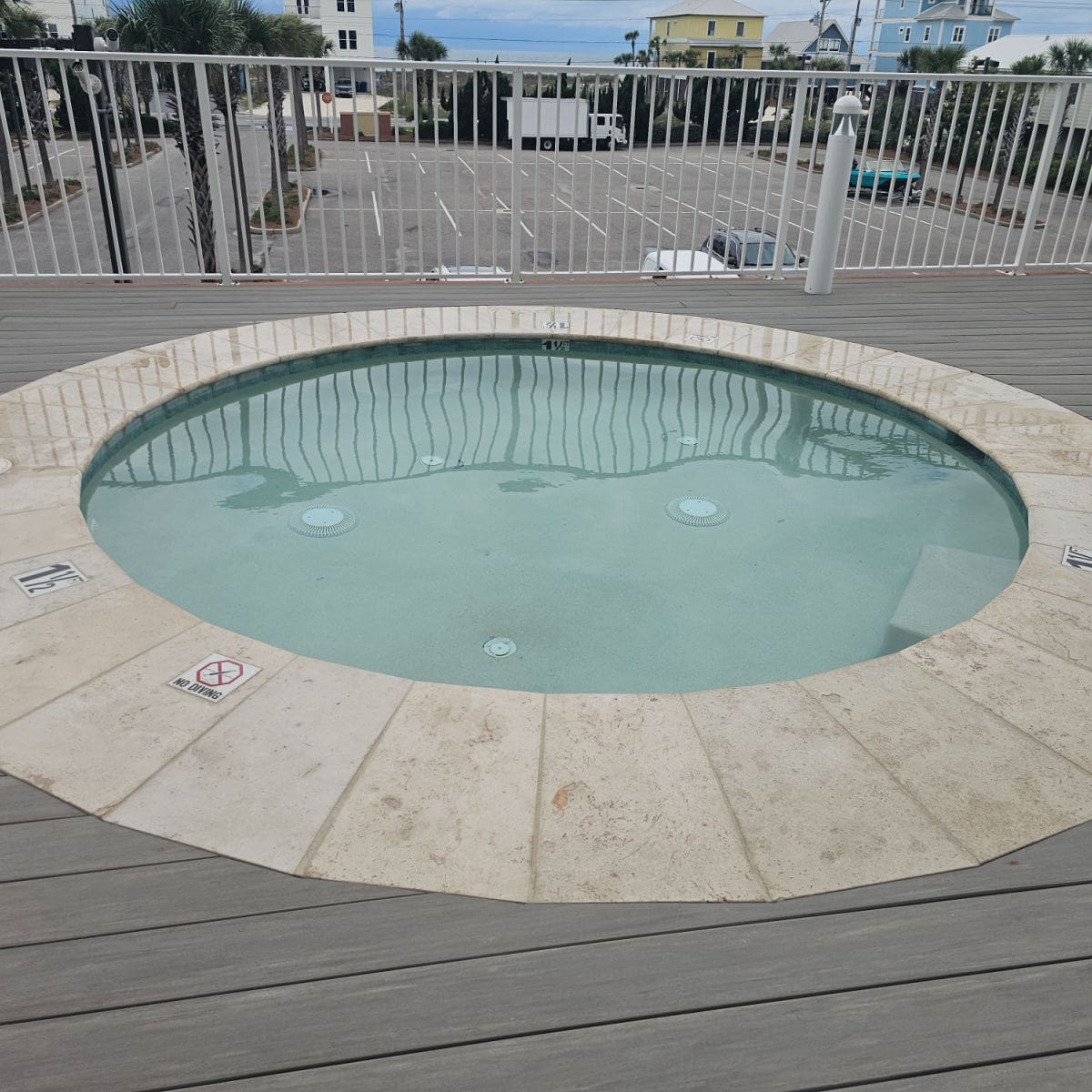 hot tub with a fence behind it
