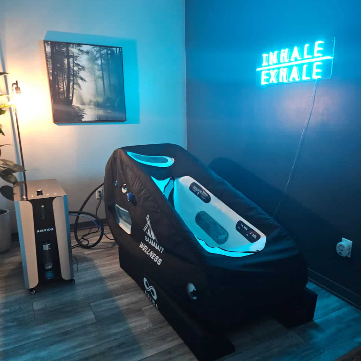 hyperbaric chamber under an inhale exhale neon sign